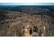 Scenic aerial view of wooded area, including the property and surrounding trees at 2370 Huckleberry Ln, Lithia Springs, GA 30122