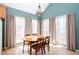 Sunlit dining area with large windows and neutral-toned window treatments at 2370 Huckleberry Ln, Lithia Springs, GA 30122