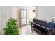 Bright foyer with plants and a piano near the front door and lots of natural light at 2370 Huckleberry Ln, Lithia Springs, GA 30122