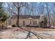 Attractive one-story home with a covered front porch, enhanced by lush landscaping and mature trees at 2370 Huckleberry Ln, Lithia Springs, GA 30122