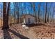 Cozy exterior structure with a covered porch, nestled amongst mature trees and a serene landscape at 2370 Huckleberry Ln, Lithia Springs, GA 30122