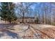 Inviting one-story home features a covered front porch and ample yard space surrounded by mature trees at 2370 Huckleberry Ln, Lithia Springs, GA 30122