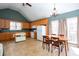 Eat-in kitchen with a tile floor, white appliances and a vaulted ceiling at 2370 Huckleberry Ln, Lithia Springs, GA 30122