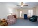 Comfortable living room featuring plush seating, a ceiling fan, and a glass door for outdoor access at 2370 Huckleberry Ln, Lithia Springs, GA 30122