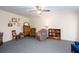 Cozy living room with comfortable armchairs, a bookshelf, and a ceiling fan at 2370 Huckleberry Ln, Lithia Springs, GA 30122