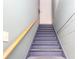 The stairway leads to a white door, featuring gray steps and a wooden handrail for support at 2370 Huckleberry Ln, Lithia Springs, GA 30122