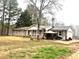 Charming brick home with covered porch and gazebo, nestled among mature trees on a spacious lot at 3750 Dial Mill Ne Rd, Conyers, GA 30013