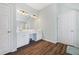 Bathroom featuring double sinks, white cabinetry, and wood-look floors at 3916 Woodruff Park Way, Buford, GA 30519