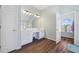 Bathroom featuring double sinks, white cabinetry, and wood-look floors at 3916 Woodruff Park Way, Buford, GA 30519