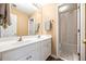 Bright bathroom featuring double sinks, white cabinets, and a separate toilet and shower at 3916 Woodruff Park Way, Buford, GA 30519