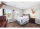 Comfortable bedroom with wood-look flooring, two windows, and mounted deer head decor at 3916 Woodruff Park Way, Buford, GA 30519