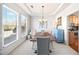 Bright dining area features a farmhouse table with seating and a view into the kitchen at 3916 Woodruff Park Way, Buford, GA 30519