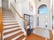 Spacious foyer with hardwood floors, staircase and front door view at 3916 Woodruff Park Way, Buford, GA 30519