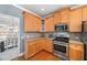 Kitchen area featuring wood cabinets, stainless steel appliances, and hardwood floors at 3916 Woodruff Park Way, Buford, GA 30519