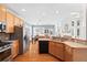 Kitchen featuring a stainless steel refrigerator and appliances, plus wood cabinetry at 3916 Woodruff Park Way, Buford, GA 30519