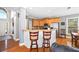 Kitchen and breakfast bar featuring wood cabinets and hardwood floors at 3916 Woodruff Park Way, Buford, GA 30519