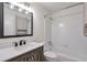 This bright bathroom includes a shower/tub combination and a neutral vanity at 128 Warm Springs Cir, Roswell, GA 30075