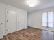 Bright bedroom featuring hardwood floors, neutral walls, and a window for plenty of natural light at 128 Warm Springs Cir, Roswell, GA 30075