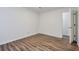 This empty bedroom has hardwood floors and neutral paint at 128 Warm Springs Cir, Roswell, GA 30075