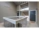 Open air condo entrance with stairs, railings, and the front door in a neutral palette at 128 Warm Springs Cir, Roswell, GA 30075