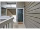 A welcoming condo entrance features a neutral door and a charming welcome mat on the porch at 128 Warm Springs Cir, Roswell, GA 30075