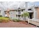 Condo building with brick and gray siding, framed by manicured landscaping, and private balconies at 128 Warm Springs Cir, Roswell, GA 30075