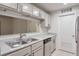 Bright kitchen with sink, dishwasher, and view to the living room at 128 Warm Springs Cir, Roswell, GA 30075