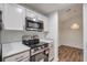 Bright kitchen with stainless appliances and view to dining area at 128 Warm Springs Cir, Roswell, GA 30075