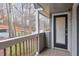 This patio offers a gray wood floor and a view of the wood line at 128 Warm Springs Cir, Roswell, GA 30075