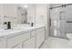 Modern bathroom with dual vanity, a spacious shower and marble-like tile at 2030 Brook Meadow Dr, Alpharetta, GA 30005