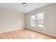 Sunlit bedroom with hardwood floors and a large window overlooking the outdoors at 2030 Brook Meadow Dr, Alpharetta, GA 30005