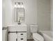 A bathroom featuring a tub with white marble tiling and a white vanity with a black faucet and black framed mirror at 3165 Dogwood Dr # 108, Hapeville, GA 30354