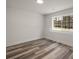 Bedroom featuring hardwood flooring, white walls, a window that overlooks the exterior and a ceiling light at 3165 Dogwood Dr # 108, Hapeville, GA 30354