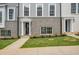 Close-up exterior shot features townhouse with stylish entryway, black door, and well-kept lawn at 3165 Dogwood Dr # 108, Hapeville, GA 30354