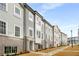 Exterior view of newly built townhomes with attractive siding and brick accents at 3165 Dogwood Dr # 108, Hapeville, GA 30354