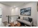 Upstairs hallway sitting area with railing, sofa, pillows, and a stylish round wood coffee table at 3165 Dogwood Dr # 108, Hapeville, GA 30354