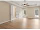 A spacious bedroom with a tray ceiling, ceiling fan, and double doors to a bathroom at 508 Price Rd, Carrollton, GA 30116