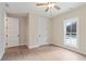 Bright bedroom with wood-look flooring, crisp white trim, and a view of the pool at 508 Price Rd, Carrollton, GA 30116