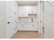 A functional laundry room featuring white cabinets, stone counters, and wood-look flooring at 508 Price Rd, Carrollton, GA 30116