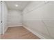 Bright walk-in closet with white wire shelving and wood-look flooring offers practical storage solutions at 508 Price Rd, Carrollton, GA 30116