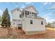 View of the white home exterior with a screened porch and shed in the leafy backyard at 51 Brookshire Ct, Dallas, GA 30157