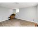 Finished basement space with wood-look flooring and neutral paint at 51 Brookshire Ct, Dallas, GA 30157