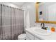 Bathroom featuring white vanity, large mirror, and shower with gray patterned curtain at 51 Brookshire Ct, Dallas, GA 30157