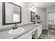 Bright bathroom with double sinks, granite counters, white cabinetry, and tile flooring at 51 Brookshire Ct, Dallas, GA 30157