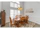 Cozy dining area with a wooden table, chairs, and a large window providing ample natural light at 51 Brookshire Ct, Dallas, GA 30157