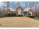 Charming red brick home featuring a well-manicured front yard and beautiful architectural details at 51 Brookshire Ct, Dallas, GA 30157