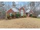 Inviting brick home with a well-kept lawn and mature landscaping at 51 Brookshire Ct, Dallas, GA 30157