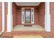 Welcoming front porch with classic brickwork and decorative columns, leading to a stylish front door at 51 Brookshire Ct, Dallas, GA 30157