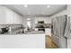 Modern kitchen featuring white cabinets, granite countertops, and stainless steel appliances at 51 Brookshire Ct, Dallas, GA 30157