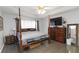 Spacious main bedroom featuring a four-poster bed, recessed lighting, and hardwood floors at 51 Brookshire Ct, Dallas, GA 30157